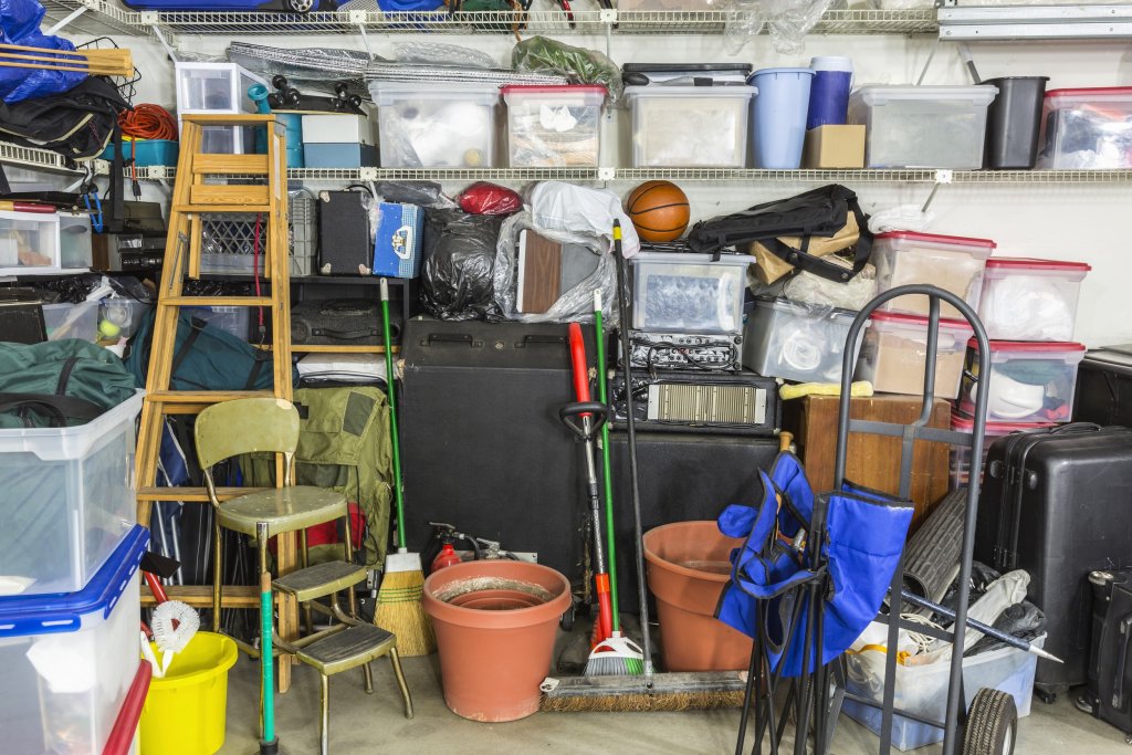 A cluttered western australian garage packed with various items, showcasing the need for removalist services, decluttering, and downsizing.